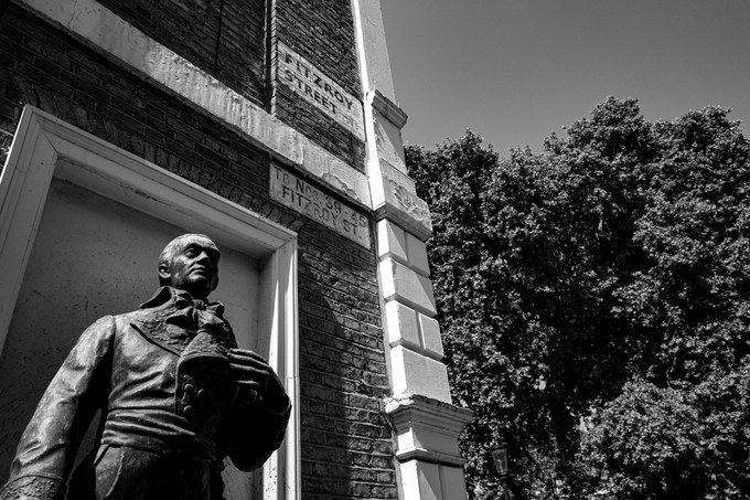 The bronze statue of Francisco de Miranda in its niche on the corner of Fitzroy Square, old street signs for Fitzroy Street on the brick above.