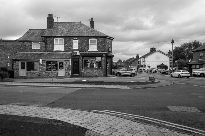 Stig's Shop, a barber's on a corner, its diamond window sign reading Est. 2003 and a barber's pole fixed to the brick.